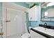 Stylish bathroom featuring white tiled shower and a vanity with sleek black countertop at 8230 Se 23Rd Dr, Webster, FL 33597