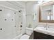 Well-lit bathroom featuring a shower-tub combo and a vanity with a framed mirror at 8230 Se 23Rd Dr, Webster, FL 33597