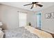 Bedroom features wood floors, a ceiling fan, and an ensuite bathroom at 8230 Se 23Rd Dr, Webster, FL 33597