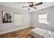 Bedroom with neutral walls, wood floors, a ceiling fan, and natural light at 8230 Se 23Rd Dr, Webster, FL 33597