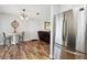 Cozy dining area features wood floors, a round table, and a stainless steel refrigerator at 8230 Se 23Rd Dr, Webster, FL 33597