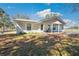 Inviting single-story home with a cozy front porch swing and manicured landscaping at 8230 Se 23Rd Dr, Webster, FL 33597