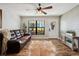 Inviting living room featuring hardwood floors, natural light, and shiplap wall detail at 8230 Se 23Rd Dr, Webster, FL 33597