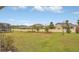 Spacious backyard with green grass, landscaping, and privacy fence at 8677 Bridgeport Bay Cir, Mount Dora, FL 32757