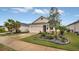 Charming single-story home with a two-car garage, stone accents, and well-manicured landscaping at 8677 Bridgeport Bay Cir, Mount Dora, FL 32757