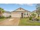 Charming single-story home with a two-car garage, stone accents, and well-manicured landscaping at 8677 Bridgeport Bay Cir, Mount Dora, FL 32757