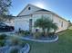 Well-maintained home exterior with a two-car garage, and decorative landscaping at 8677 Bridgeport Bay Cir, Mount Dora, FL 32757