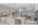 Elegant kitchen with a center island, granite countertops, stainless steel appliances, and stylish pendant lighting at 8677 Bridgeport Bay Cir, Mount Dora, FL 32757