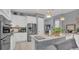 Modern kitchen featuring white cabinetry, stainless steel appliances, and a granite-topped island at 8677 Bridgeport Bay Cir, Mount Dora, FL 32757