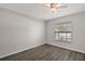 Bedroom featuring new floors, ceiling fan and a picture window at 8721 Se 159Th Pl, Summerfield, FL 34491