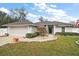 Charming single-story home with well-maintained landscaping and an attached two-car garage at 8721 Se 159Th Pl, Summerfield, FL 34491