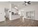 Open-concept living room with wood-look flooring seamlessly connecting to kitchen and dining area at 8721 Se 159Th Pl, Summerfield, FL 34491