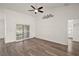 Bright living room featuring a ceiling fan, sliding glass door, and wood-look flooring at 8721 Se 159Th Pl, Summerfield, FL 34491