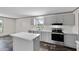 Bright kitchen featuring an island, stainless steel appliances, and light-colored cabinetry at 909 Lake Thomas Rd, Lake Wales, FL 33898