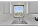 Bright view of a stainless steel kitchen sink with light colored countertops at 909 Lake Thomas Rd, Lake Wales, FL 33898