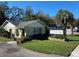 Charming one story commercial building featuring well maintained lawn, palm tree and elegant signage at 911 N Donnelly St, Mount Dora, FL 32757