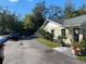 A large commercial parking lot, with adjacent landscaping and potted plants at 911 N Donnelly St, Mount Dora, FL 32757