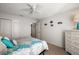 Bedroom featuring a bed with blue floral comforter, closet, and ocean-themed decorations at 9243 Se 171St Cooper Loop, The Villages, FL 32162