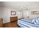 Bright bedroom with ceiling fan, wood floors and nautical themed decor at 9243 Se 171St Cooper Loop, The Villages, FL 32162