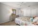 Bedroom featuring a wicker dresser, ceiling fan, and a bed with colorful ocean-themed decorations at 9243 Se 171St Cooper Loop, The Villages, FL 32162