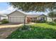 Charming home with a well-manicured lawn, beautiful landscaping, and a two-car garage at 9243 Se 171St Cooper Loop, The Villages, FL 32162