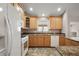 Bright kitchen with wooden cabinets, granite countertops and white appliances at 9243 Se 171St Cooper Loop, The Villages, FL 32162