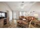 Bright living room with comfortable seating, ceiling fan, and lots of natural light at 9243 Se 171St Cooper Loop, The Villages, FL 32162