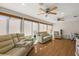 Inviting sunroom features hardwood floors, multiple ceiling fans, and lots of natural light at 9243 Se 171St Cooper Loop, The Villages, FL 32162