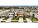 Aerial view of neighborhood and street showing similar two story homes with green lawns at 3040 Tansy St, Tavares, FL 32778