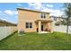 Exterior back view of house showing back patio, yard and privacy fence at 3040 Tansy St, Tavares, FL 32778