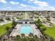 Aerial view of the pristine community pool, clubhouse, playground, and surrounding neighborhood in Avalon Park at 3040 Tansy St, Tavares, FL 32778