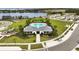 Aerial view of a community pool with clubhouse, playground, sidewalks, and a lake view in Avalon Park at 3040 Tansy St, Tavares, FL 32778