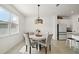 Bright dining room with a round table, upholstered chairs, and modern pendant lighting fixture at 3040 Tansy St, Tavares, FL 32778