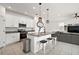 Well-lit kitchen featuring granite countertops, stainless steel appliances, a kitchen island, and modern lighting at 3040 Tansy St, Tavares, FL 32778