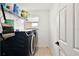 Laundry room with side by side washer and dryer and wire rack shelving unit at 3040 Tansy St, Tavares, FL 32778