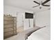 Bedroom featuring a large dresser, modern ceiling fan, and neutral decor at 3040 Tansy St, Tavares, FL 32778