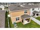 Aerial view of the rear exterior and backyard showing a covered patio and privacy fence at 3040 Tansy St, Tavares, FL 32778