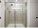 Tiled shower with glass doors and modern fixtures at 3040 Tansy St, Tavares, FL 32778