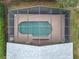 Aerial view of a screened-in pool and patio area, surrounded by greenery at 1007 Balmoral Dr, Davenport, FL 33896