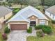 Aerial view of a well-maintained single-story house with a light gray roof and manicured landscaping at 1007 Balmoral Dr, Davenport, FL 33896