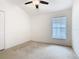 Bedroom featuring carpet flooring, a ceiling fan and a window with blinds at 1007 Balmoral Dr, Davenport, FL 33896