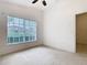 Bedroom featuring carpet flooring, a ceiling fan and a window with blinds at 1007 Balmoral Dr, Davenport, FL 33896