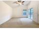 Bright bedroom with a ceiling fan, natural light and sliding glass doors to the pool area at 1007 Balmoral Dr, Davenport, FL 33896