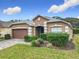 Charming single Gathering home featuring a well manicured lawn, beautiful brick driveway and two car garage at 1007 Balmoral Dr, Davenport, FL 33896