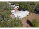 Overhead view of a single-story home with metal roof and mature tree cover at 11642 Martell Ct, Leesburg, FL 34788