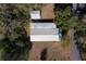 Overhead shot of home with metal roof showcasing foliage and street access at 11642 Martell Ct, Leesburg, FL 34788