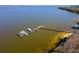 Aerial view of a lake with docks, boats, and a vibrant shoreline, showcasing the serene waterfront setting at 11642 Martell Ct, Leesburg, FL 34788