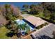 Aerial view from the lake showing clubhouse, community pool, parking and the dock at 11642 Martell Ct, Leesburg, FL 34788