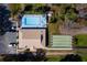 Aerial view of community pool, shuffleboard court, parking and clubhouse at 11642 Martell Ct, Leesburg, FL 34788