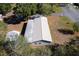 Aerial view of home with metal roof and well-maintained landscaping at 11642 Martell Ct, Leesburg, FL 34788